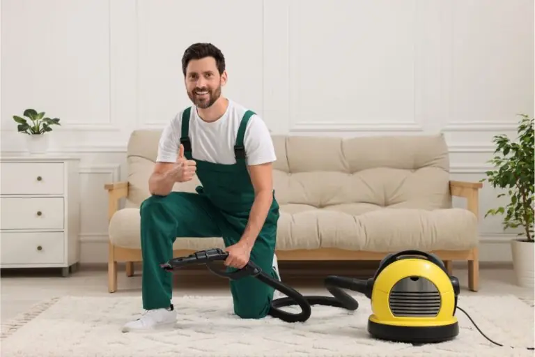 dry cleaners employee hoovering carpet with vacuum