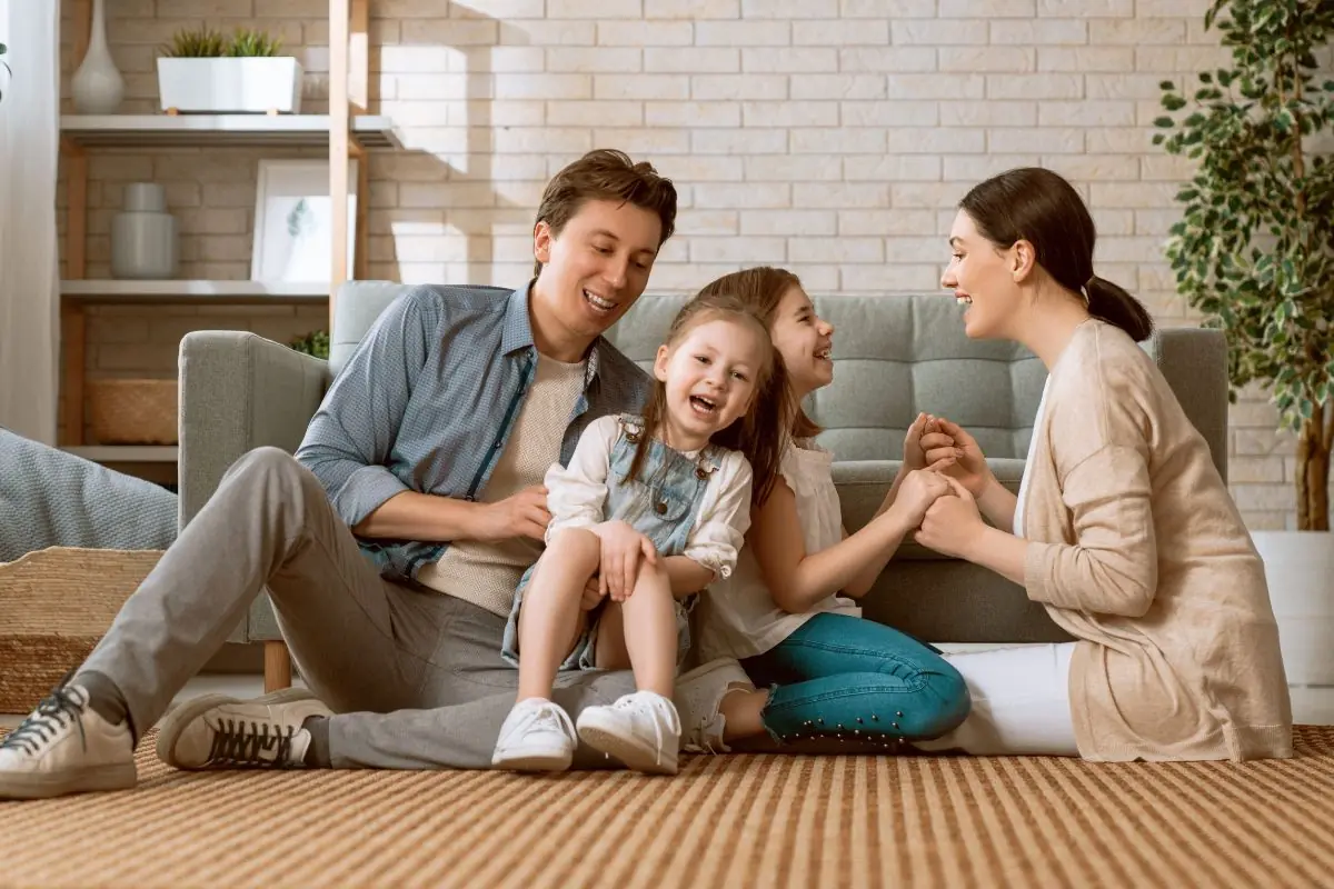 young family sitting on the carpet